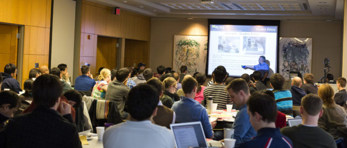 An audience listening to a presentation in the Johnson Room